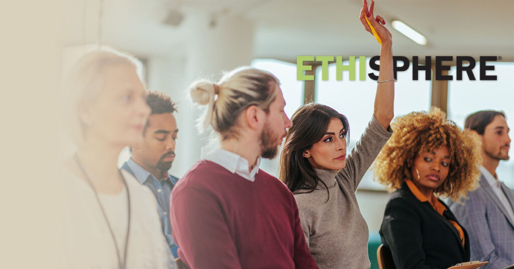 Woman raising hand in meeting
